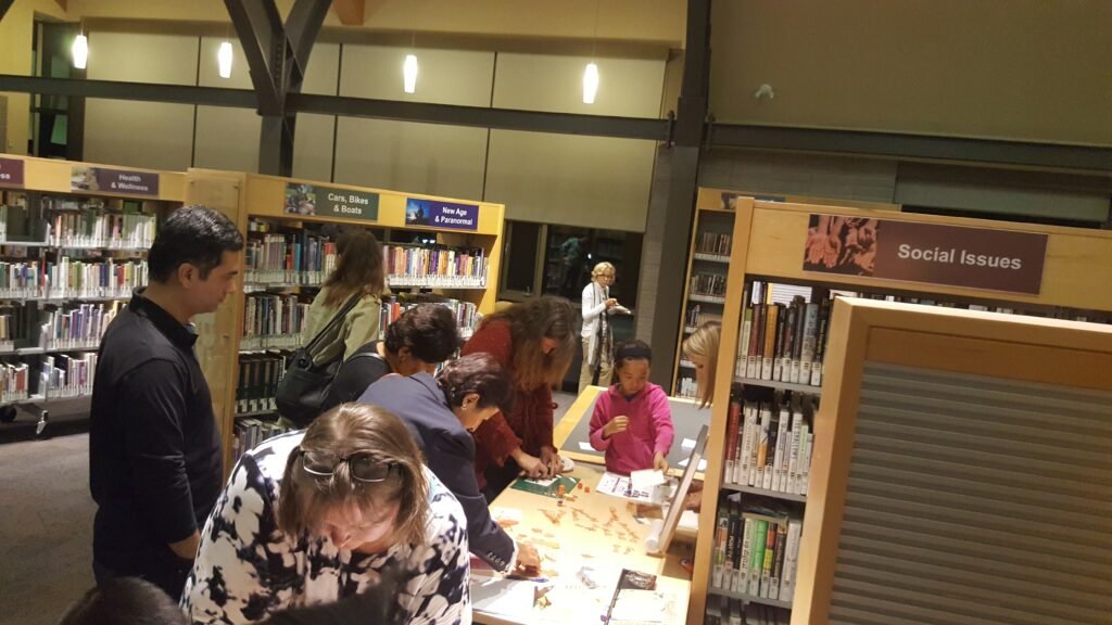Paper-crafting table setup during Pecha Kucha at Markham Public Library, where I facilitated hands-on creative activities.